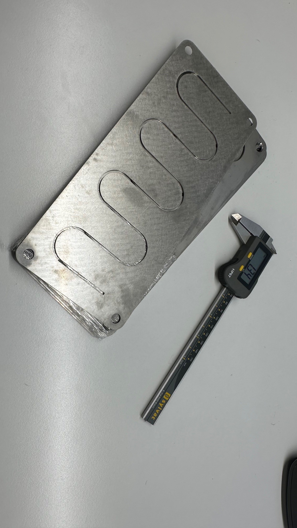 Plaque inox usinée, contrôle au pied à coulisse